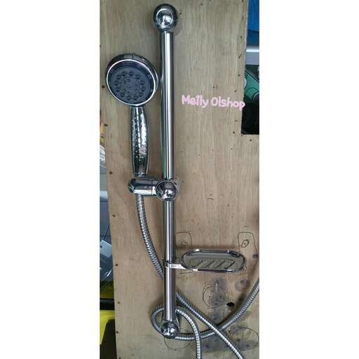 a chrome water faucet on a wooden wall.