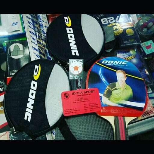 a racket and some tennis rackets on a table.