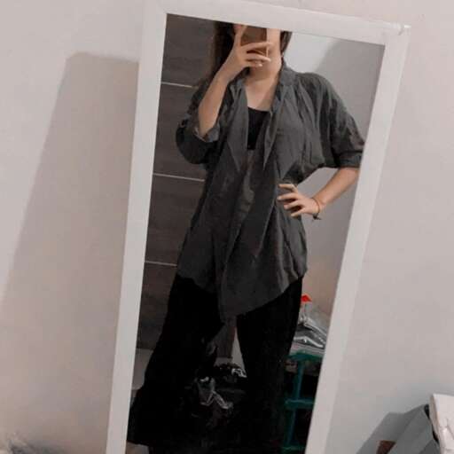 a woman in black pants and a long sleeve shirt