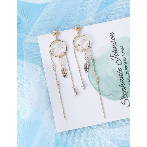 a pair of gold earrings with a turquoise background.
