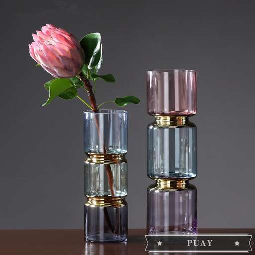 a pink flower in a glass bottle with a pink flower in it.