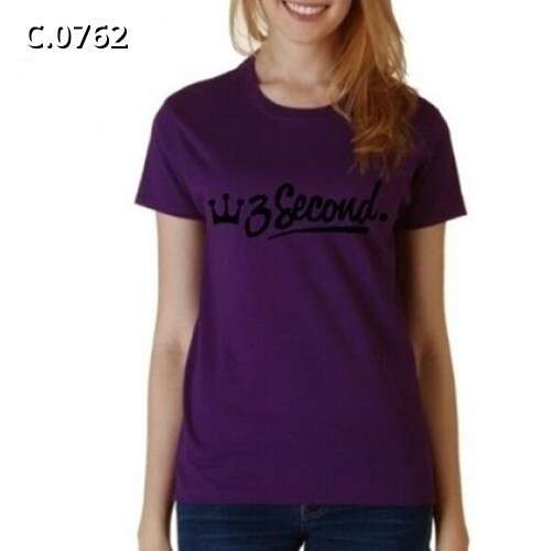 a woman wearing a purple shirt with a black print on it.