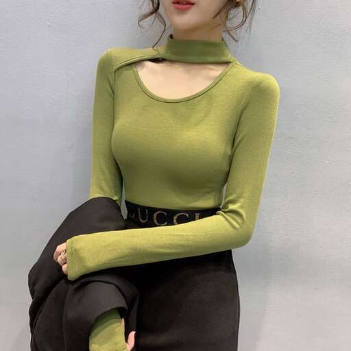 a model in a green top and black skirt