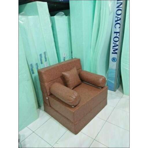 a chair in a room with a blue curtain.