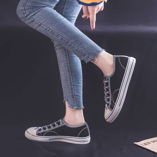a girl in a pair of jeans and a baseball cap