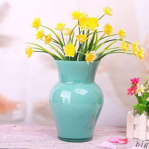a blue vase with yellow flowers in it.