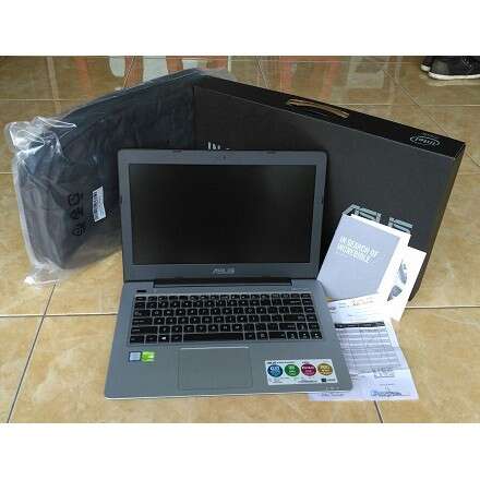 a laptop computer sitting on top of a plastic bag.