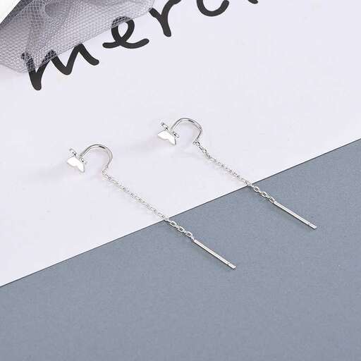a pair of earrings with a heart shaped chain.