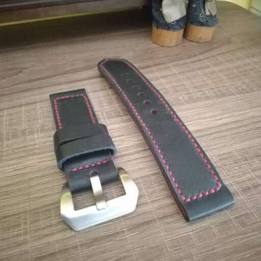 a black leather belt with a buckle and a buckle.