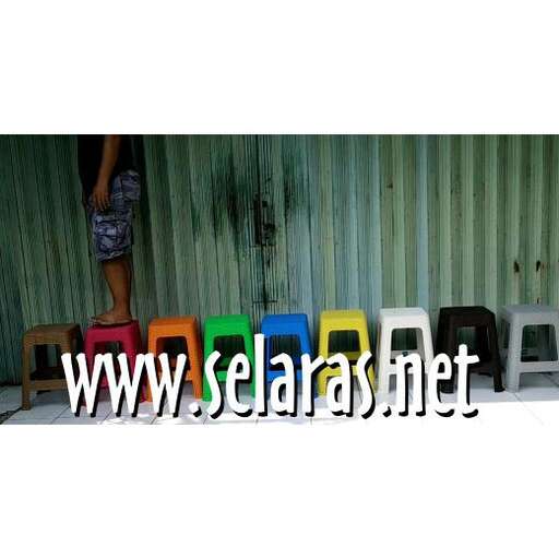a person standing next to a row of chairs.