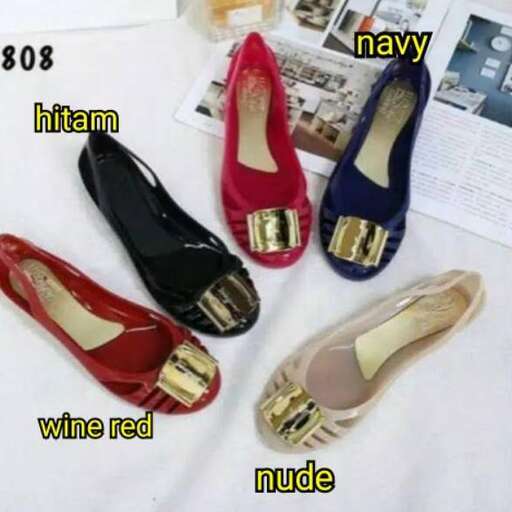 a pair of red shoes with gold accents.