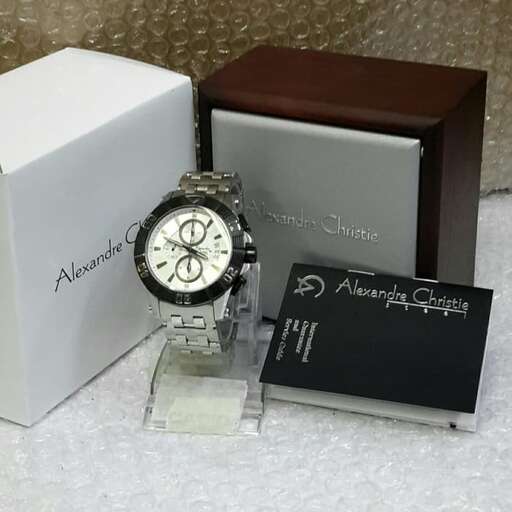 a watch and a box are on a table.