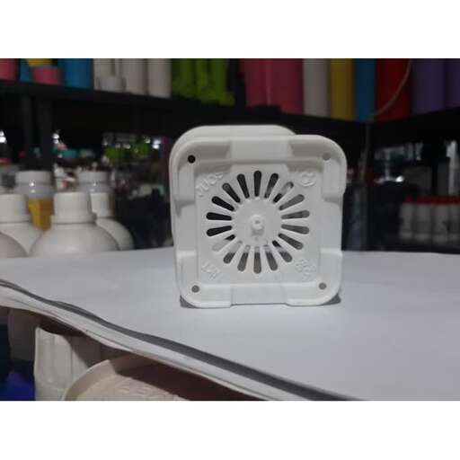 a white toaster sitting on a table.