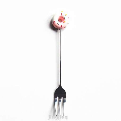 a spoon with a strawberry on it