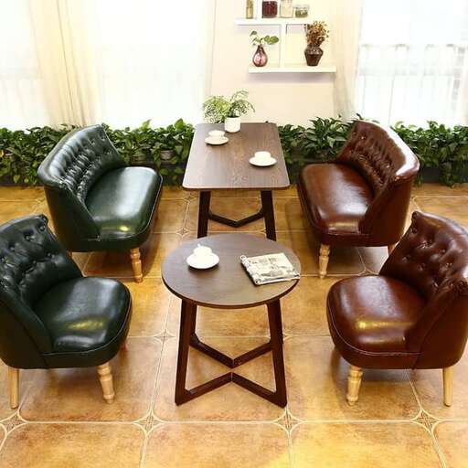 a set of leather chairs and a table in a room.