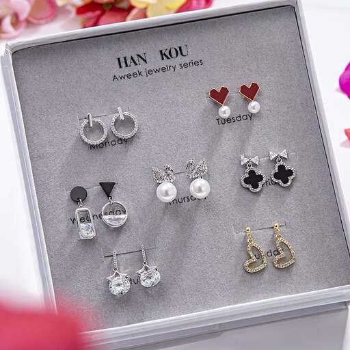a box of earrings with a pair of earrings in it.