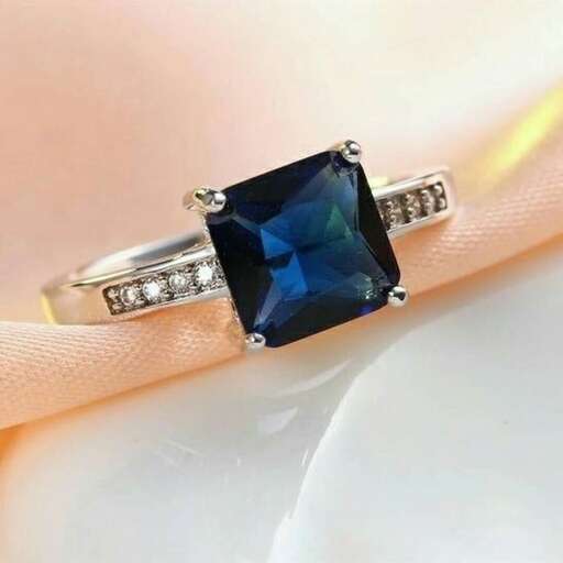 a sapphire and diamond ring, by person.