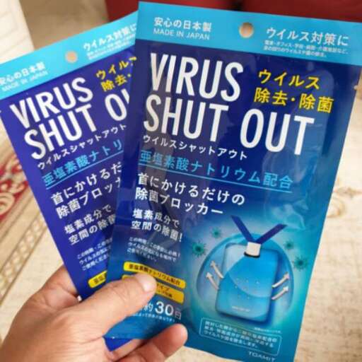 a person holds up a packet of cigarettes.