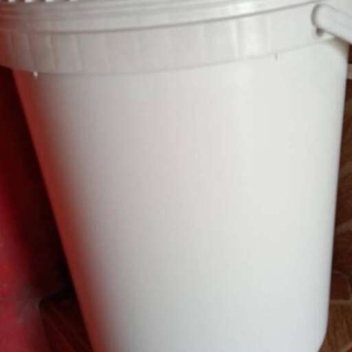 a bucket of milk is placed on the counter.