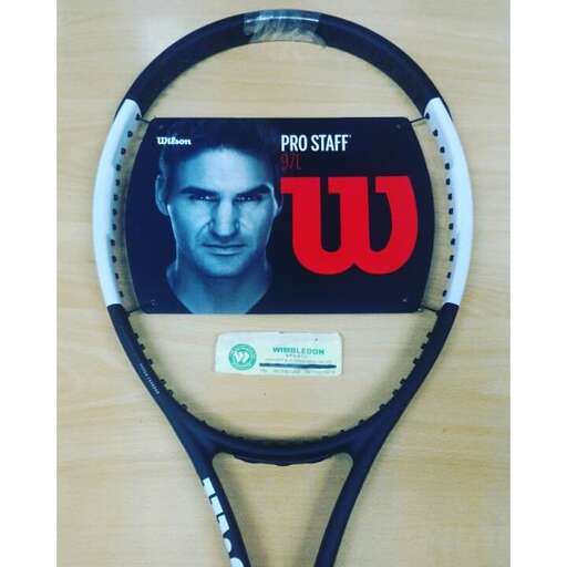 a tennis racket with a picture of a man on it.