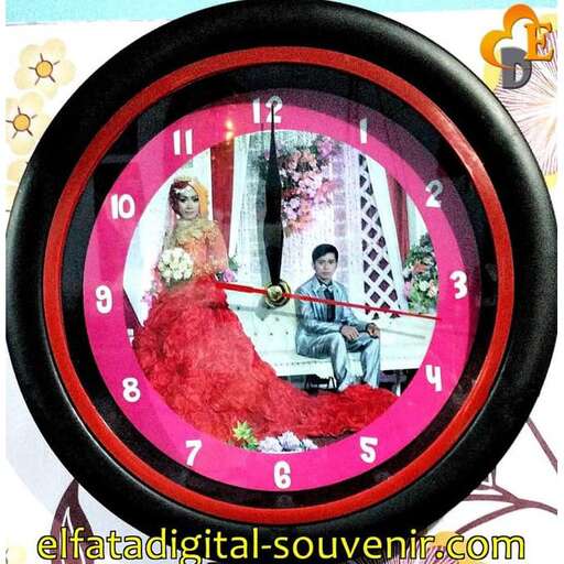 a picture of a woman and a man looking at a clock.