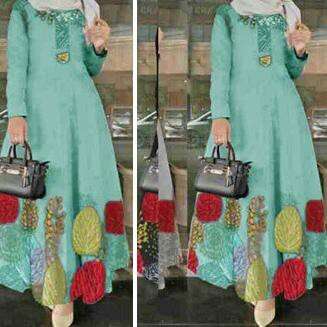 a woman in a green dress with a handbag