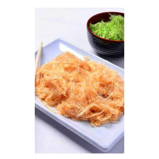 a plate of fried chicken with a bowl of green vegetables