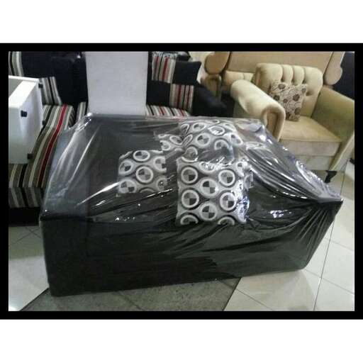 a couch covered in plastic and plastic.