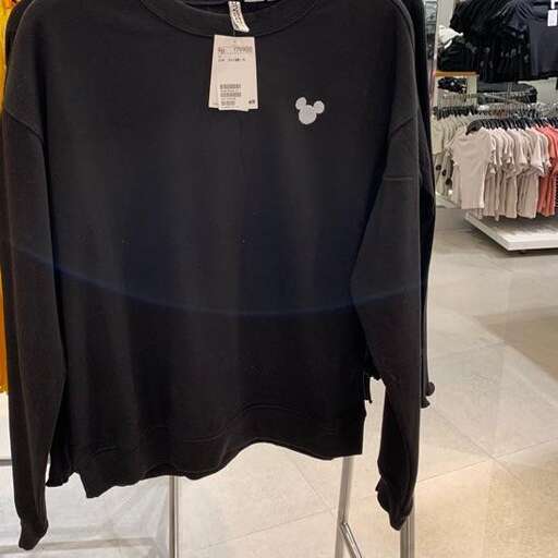 a black long sleeve shirt with a bird on the front.