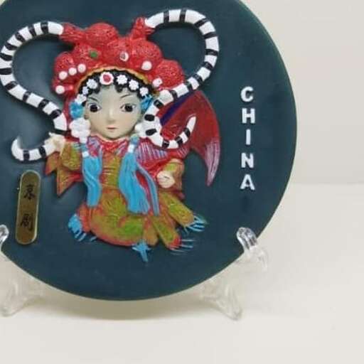 a ceramic plate with a girl and a chinese lantern.