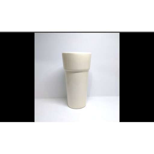 a white ceramic cup with a curved top and a curved top.