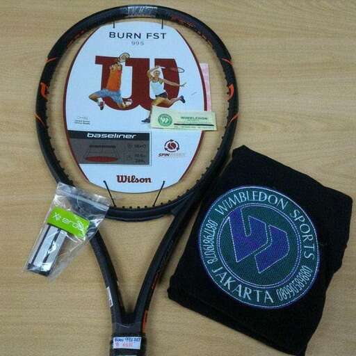 a tennis racket and a bag on a table.