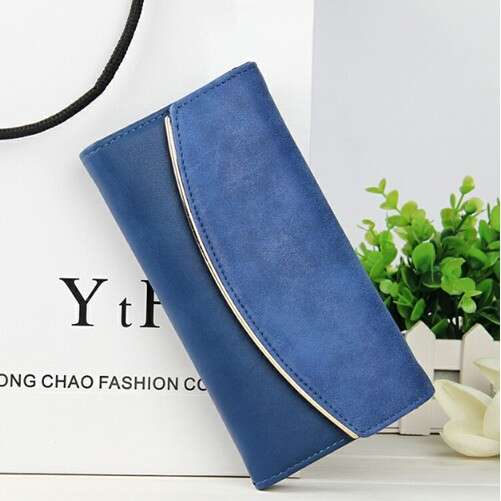 a small pouch with a strap and a small plant in it.