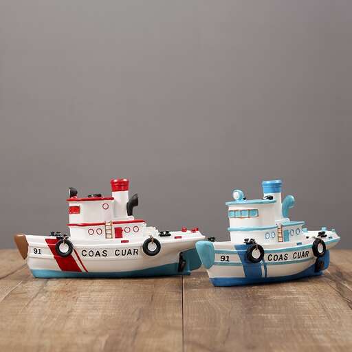 a toy boat and a small boat on a wooden floor.