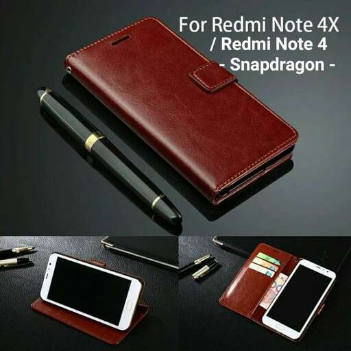 a brown leather wallet with a pen on top of it.