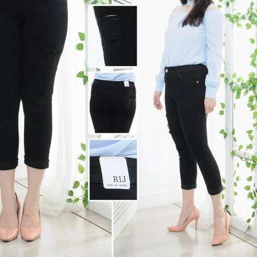 a woman stands in front of a shelf with a pair of leggings.