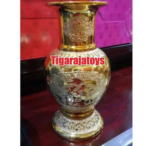 a gold vase with a gold base on a table.