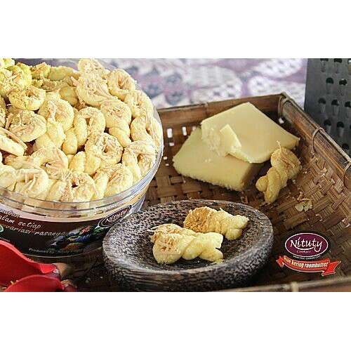 a basket of food with a bowl of cheese.