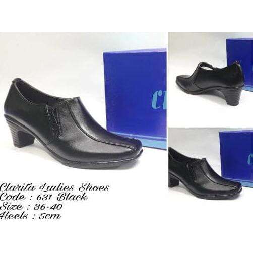 a pair of black shoes with a blue logo on the side.